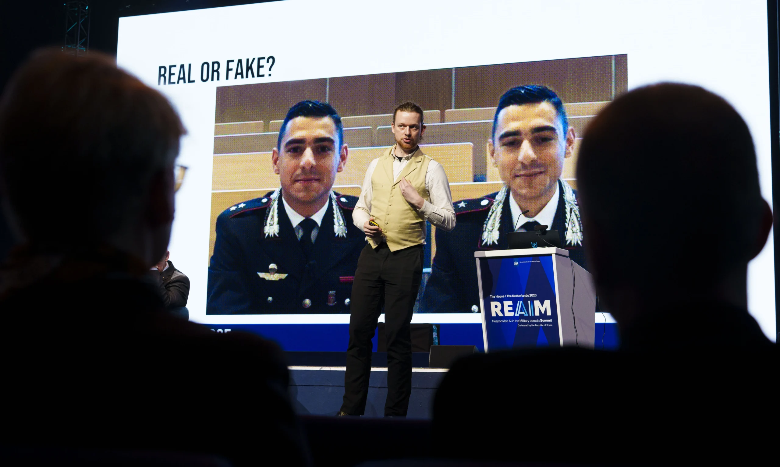 Exhibit display asking 'is it real or fake?' illustrating how AI deepfake scams manipulate video and audio