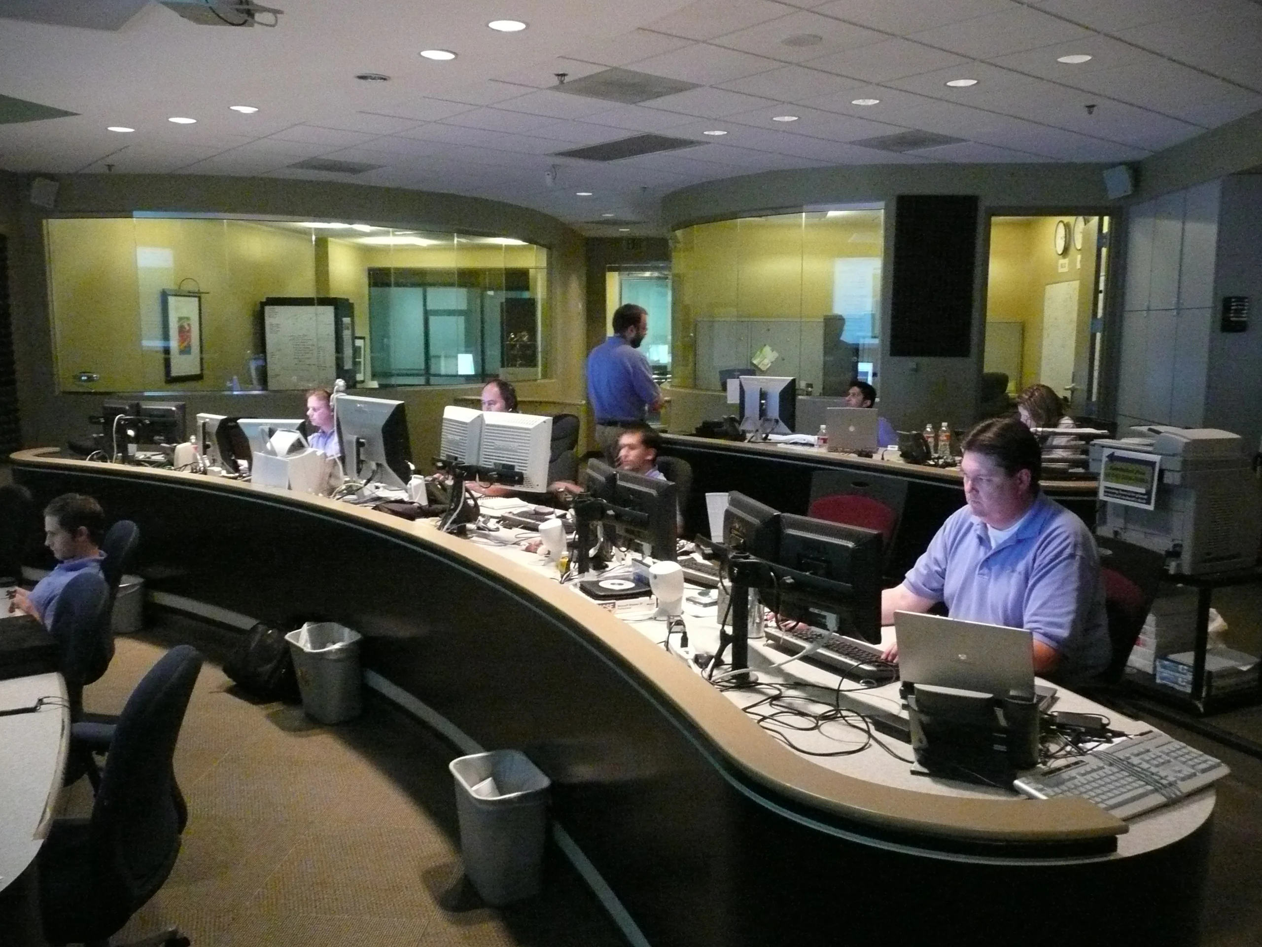 Technicians monitoring screens in a network operations center, illustrating the continuous monitoring central to the edr vs antivirus comparison
