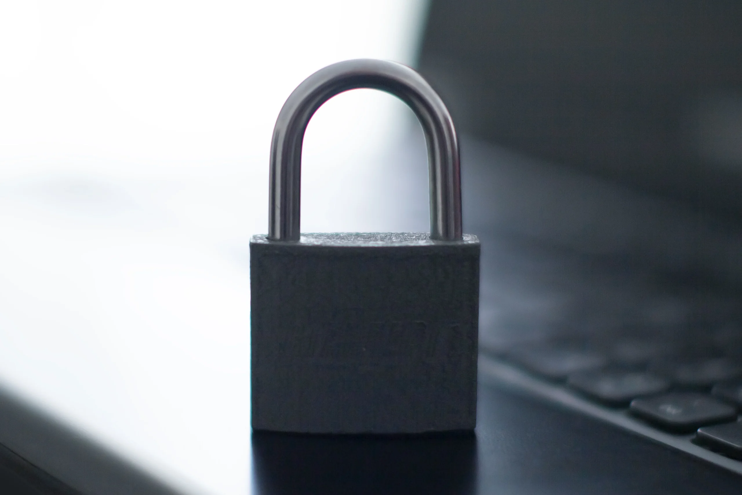 Laptop with a closed padlock, representing the search for legitimate protection instead of a nonexistent madonna antivirus product