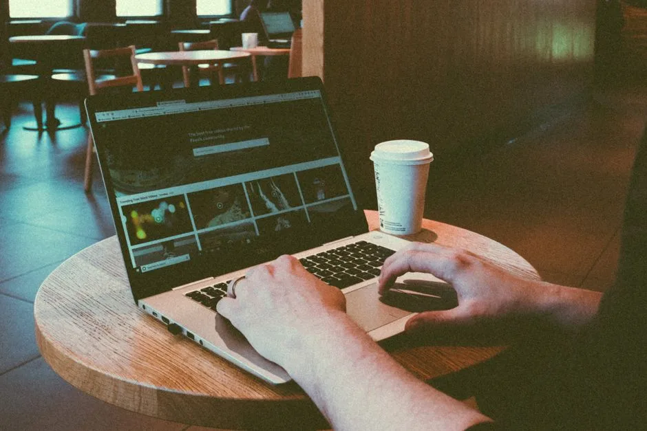 Person browsing on a laptop in a cafe, representing everyday VPN browsing