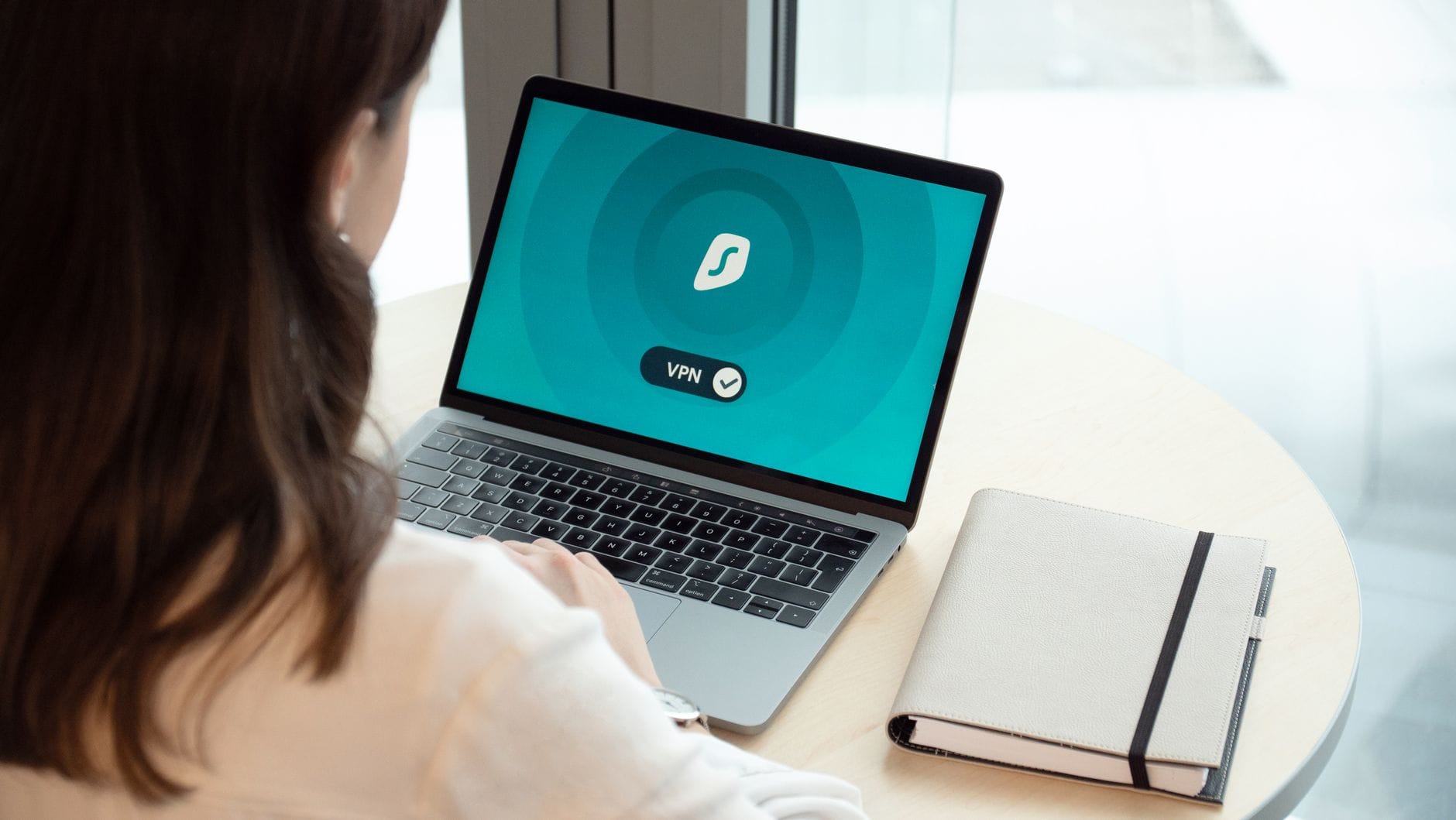 Woman using MacBook with VPN for privacy
